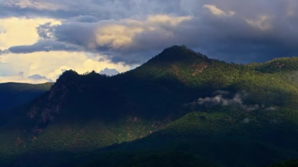 Timelapse Clouds swirl over a green mountain valley — Stock Video
