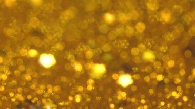 Altın hareketli bokeh pırıltılı duvar kâğıdı Noel, yeni yıl ya da diğer şenlikli arka planlar için mükemmel. Yüksek kalite 4k görüntü