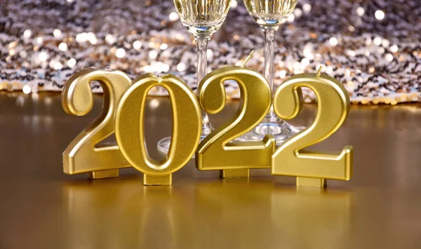 New Year 2022 golden candles stock images. New Year\'s Eve party 2022 golden shiny background stock images. Gold decoration for the year 2022 stock photo