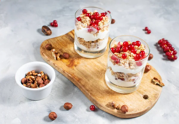 Healthy breakfast menu concept. Morning granola breakfast with berries served with yogurt in glasses.