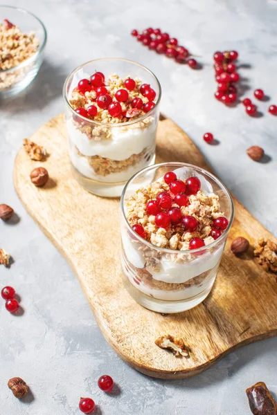 Healthy breakfast menu concept. Morning granola breakfast with berries served with yogurt in glasses.