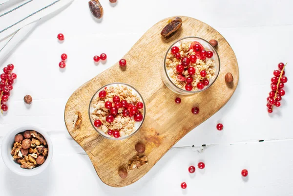 Healthy breakfast menu concept. Morning granola breakfast with berries served with yogurt in glasses.