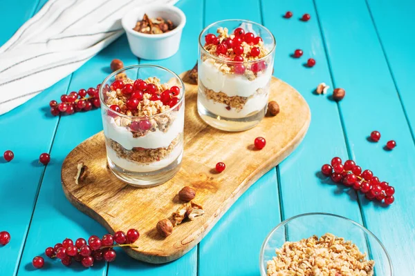 Healthy breakfast menu concept. Morning granola breakfast with berries served with yogurt in glasses.