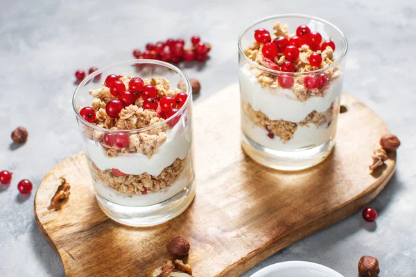 Healthy breakfast menu concept. Morning granola breakfast with berries served with yogurt in glasses.