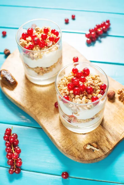 Healthy breakfast menu concept. Morning granola breakfast with berries served with yogurt in glasses.