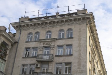 An old building in the city against the blue sky with clouds
