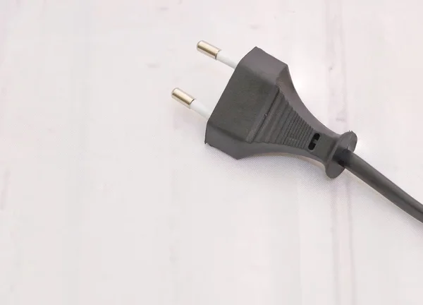 Closeup shot of a black short cable with two plugs on the white background — 스톡 사진