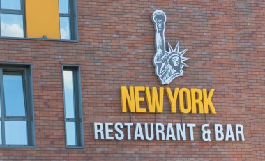 Chisinau, Moldova - 2 Ağustos 2022 Tuğla bir binaya bağlı Özgürlük Heykeli ve New York Restoran Barı gibi bir metin.
