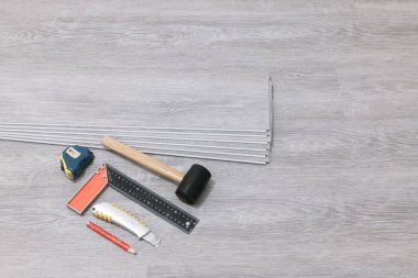 Laminate flooring. Repair floor work. Tools for laying parquet and laminate, vinyl boards.
