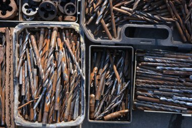 Testere üzerinde eski daireler. Antika koleksiyonu için bit pazarında ya da garajda satılan eski paslı metal ve pirinç parçalarını toplu olarak gösteren eski matkaplar. Paslı tuşlar ve araçlar 