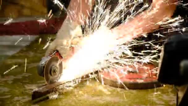 家里的工人用磨床切割金属 手拿着工作手套 许多发光的火花来自于电子设备的操作 金属加工和切割 锁匠工作 — 图库视频影像