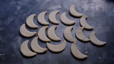 Patterned shortbread cookies.Sweet pastries before baking, darkened and sloppy background with scattered flour, the process of making sweets