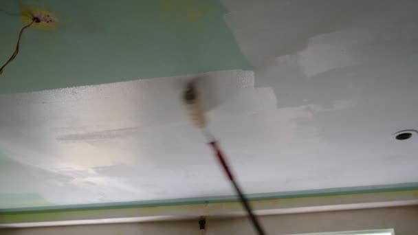 Muž Domě Provádí Opravy Maluje Strop Dlouhou Tyčí Kolečkem Strop — Stock video