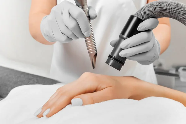 Female cosmetologist making a young woman a procedure laser hair removal for hands. Cosmetology, ionization, diamond procedures. — Stock Photo, Image