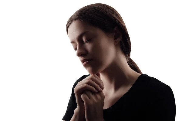 Γυναικεία σιλουέτα με διπλωμένα τα χέρια της για να προσευχηθεί σε λευκό φόντο — Φωτογραφία Αρχείου