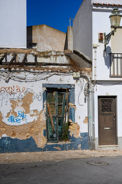 An old uninhabited house decorated with graffiti shortly before it was demolished.