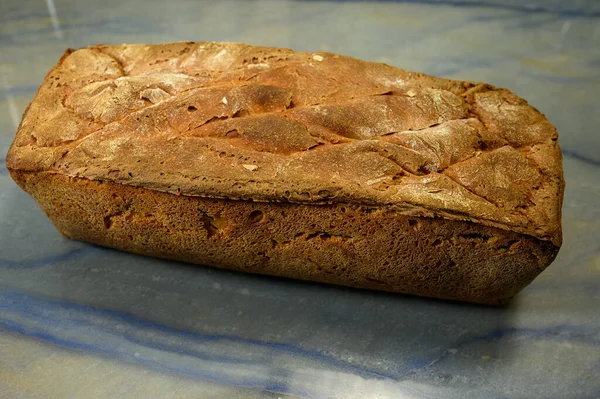 Piece Bread Has Just Been Made Baked Lies Stone Slab — Stock Photo, Image