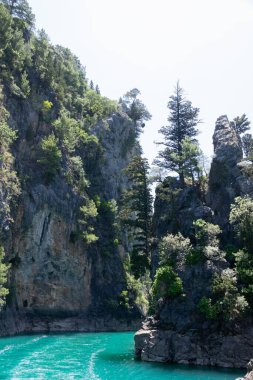 Temiz turkuaz suyla göl manzarası ve Yeşil Kanyon 'un dağ kayalıkları. Yeşil Kanyon, Manavgat, Antalya, Türkiye