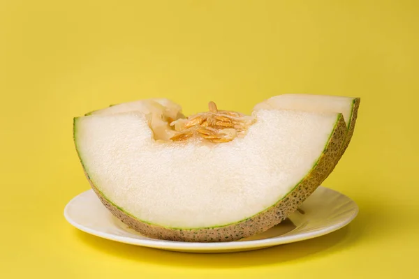 sliced slices of ripe melon on a yellow background.