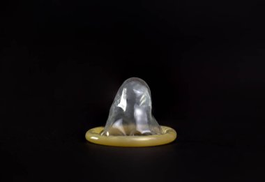 Doğum kontrol, siyah arka planda yakın plan prezervatif demektir..