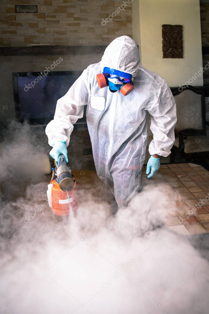 a professional disinfects the room with an antiseptic.
