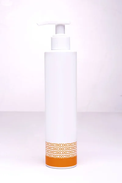 Witte Fles Voor Cosmetica Met Een Oranje Patroon Een Witte — Stockfoto