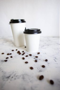 Fasulyeli karton kahve. Karton bardaklar ve kahve çekirdekleri.