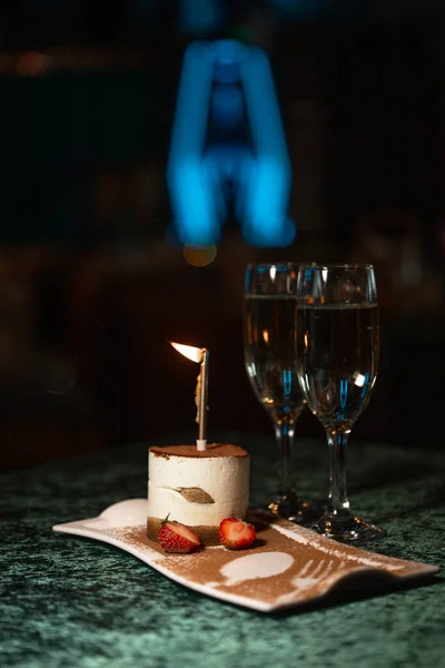 dessert with a hot candle on the table in a restaurant. romantic table in for a meeting.