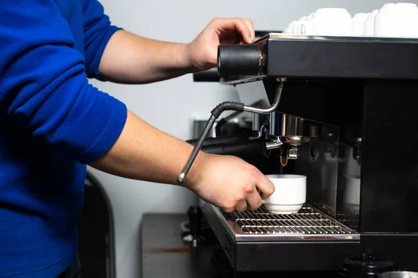 the process of making coffee. the guy makes coffee.