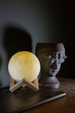 Moon lamp on the desktop in a dark room.