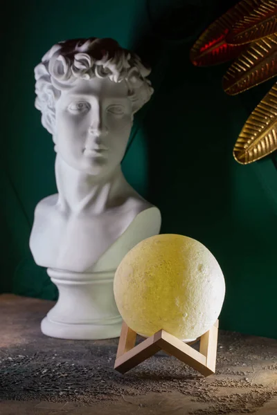 Moon lamp on the desktop in a dark room.