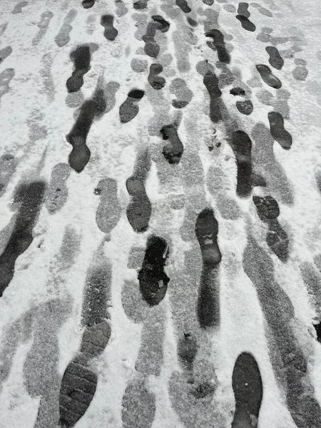 Footprints on a snowy road. winter trail.