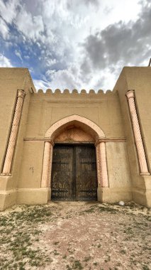 the gates of an ancient fortress in the desert.