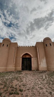 the gates of an ancient fortress in the desert.