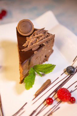 chocolate cheesecake close-up on a white plate.