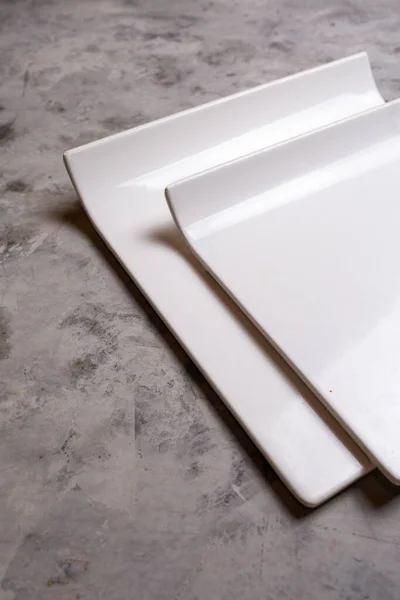 White Ceramic Square Plates Concrete Background — Stockfoto