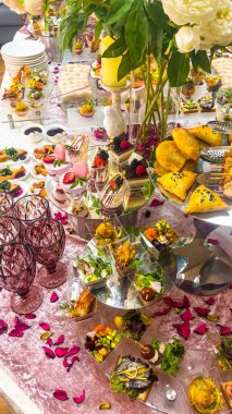 catering table covered with snacks and various dishes top view.