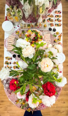 catering table covered with snacks and various dishes top view.