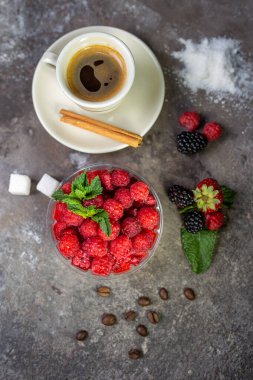 top view dessert with fresh raspberries and a cup of coffee on a concrete background.