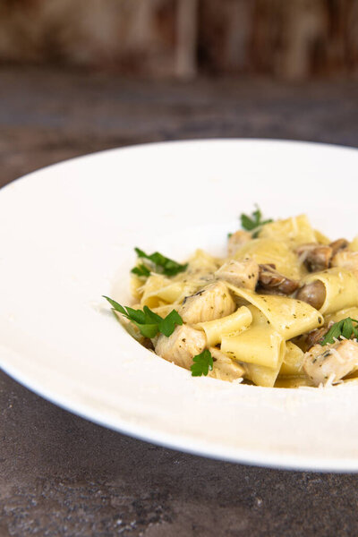 Fettuccine chicken with mushrooms in cream sauce.