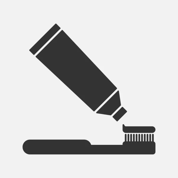 Cepillo de dientes y pegar icono de vector. Higiene dental — Vector de stock