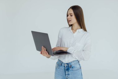 Portrait of a happy woman working on laptop computer isolated over white background