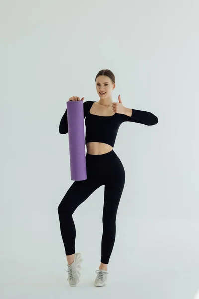Beautiful Young Girl Sportswear Holding Yoga Mat Giving Thumbs Isolated — Stock Fotó