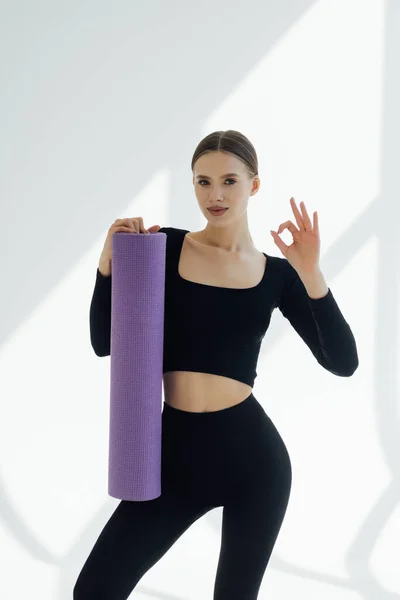 Beautiful Young Girl Sportswear Holding Yoga Mat Giving Thumbs Isolated Лицензионные Стоковые Изображения