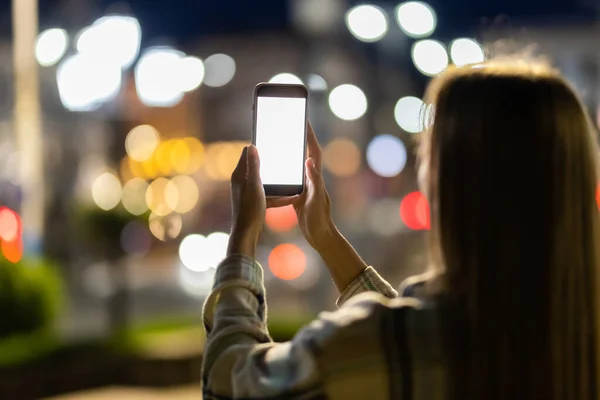 Young Woman Holding Mobile Phone Blank White Display Background Light Imagen de stock