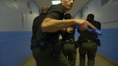 Bir grup polis okul çatışmalarına müdahale etmek için silahlarını kuşanmış bir şekilde okula giriyor..