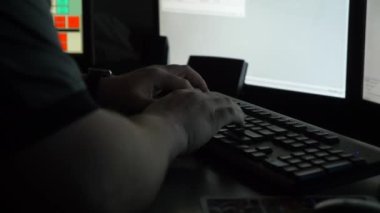 Bir 911 memuru, acil aramalara cevap vermek için kontrol merkezindeki bilgisayar istasyonunda çalışıyor..