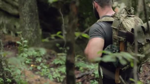 男性ハイカーの詳細浅いフォーカスとスローモーションで森の中を歩く — ストック動画