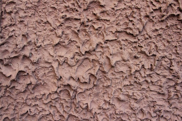 Old painted concrete surface closeup, light pink background texture mockup for wallpaper