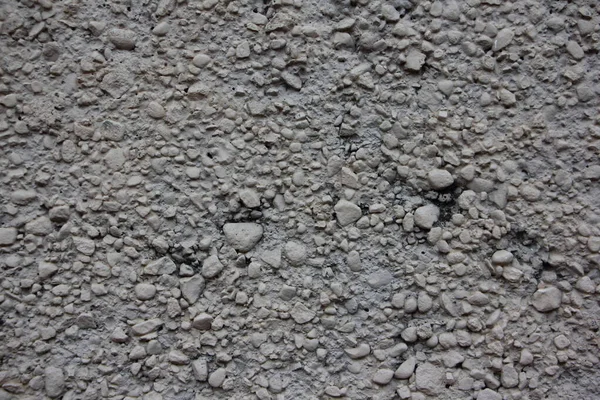 Sert gri kuru beton yüzey ezilmiş taşla karışmış endüstriyel arkaplan dokusunu kapatın